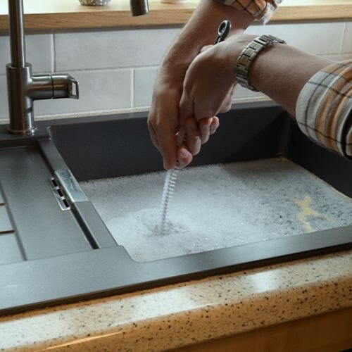 Professional kitchen sink overflow cleanup service underway at a property in Pembroke Pines, FL