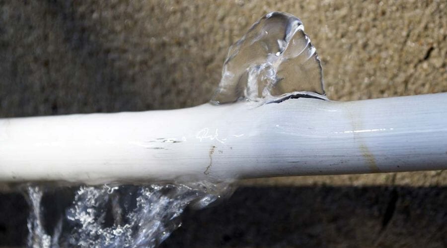 Restoration technicians assessing moisture and documenting damage for a claim