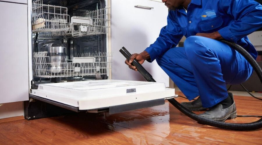 Professional dishwasher leak cleanup service underway at a property in Baytown, TX